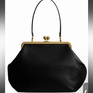 Brand new in packaging. NWT Coach Kisslock black Leather Bag with Gold.